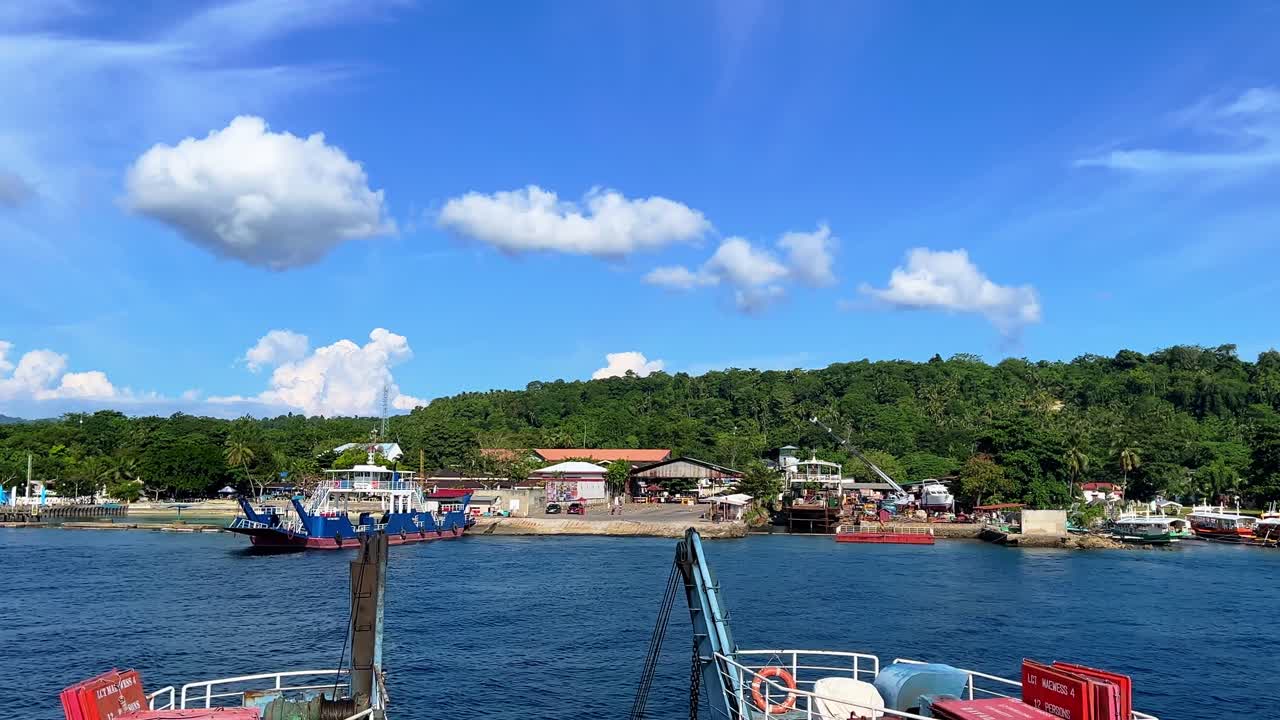 Colorful ferry boats docked at a tropical island port under sunny skies. Ideal for tourism, transportation, coastal life, and island travel themes