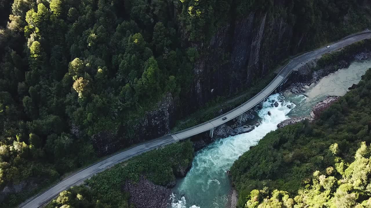 Birds Eye Aerial View of Canyon Road and Alpine River in Amazing Landscape of Chilean Patagonia