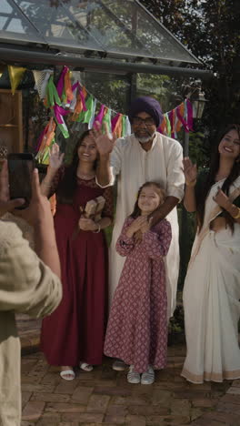 happy indian family posing for a photo in an outdoor celebration