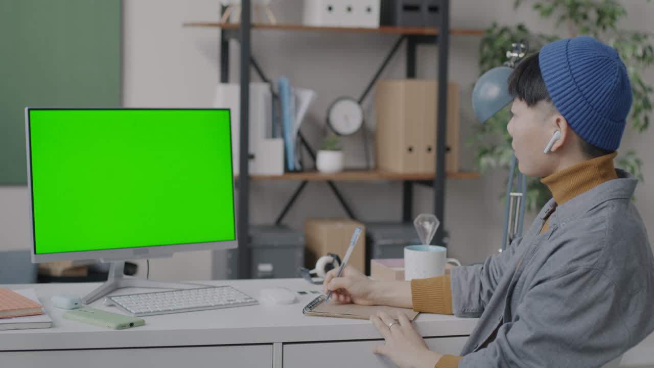 Person taking notes during an online class or meeting