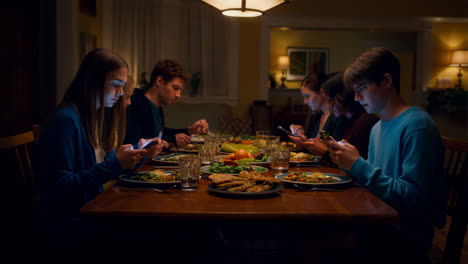 family dinner distracted by smartphones