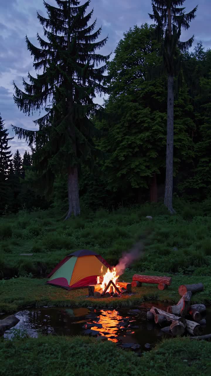 A serene camping scene with a tent and campfire at dusk, captured from a low angle, perfect