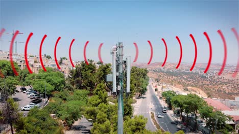 cell tower with radio waves in urban area