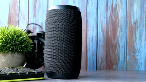 close up of smart speaker and diary on table