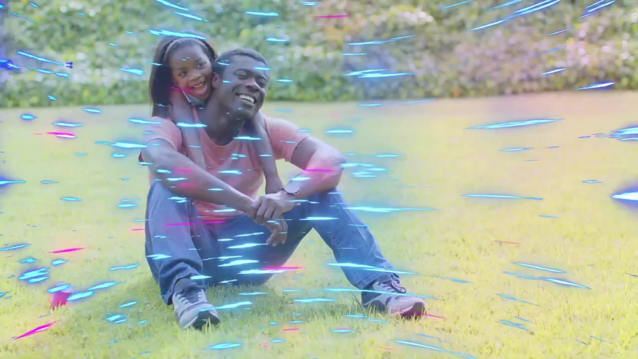 dad sitting lawn girl leaning wrapping hugging blue purple streaks sweeping across family bonding