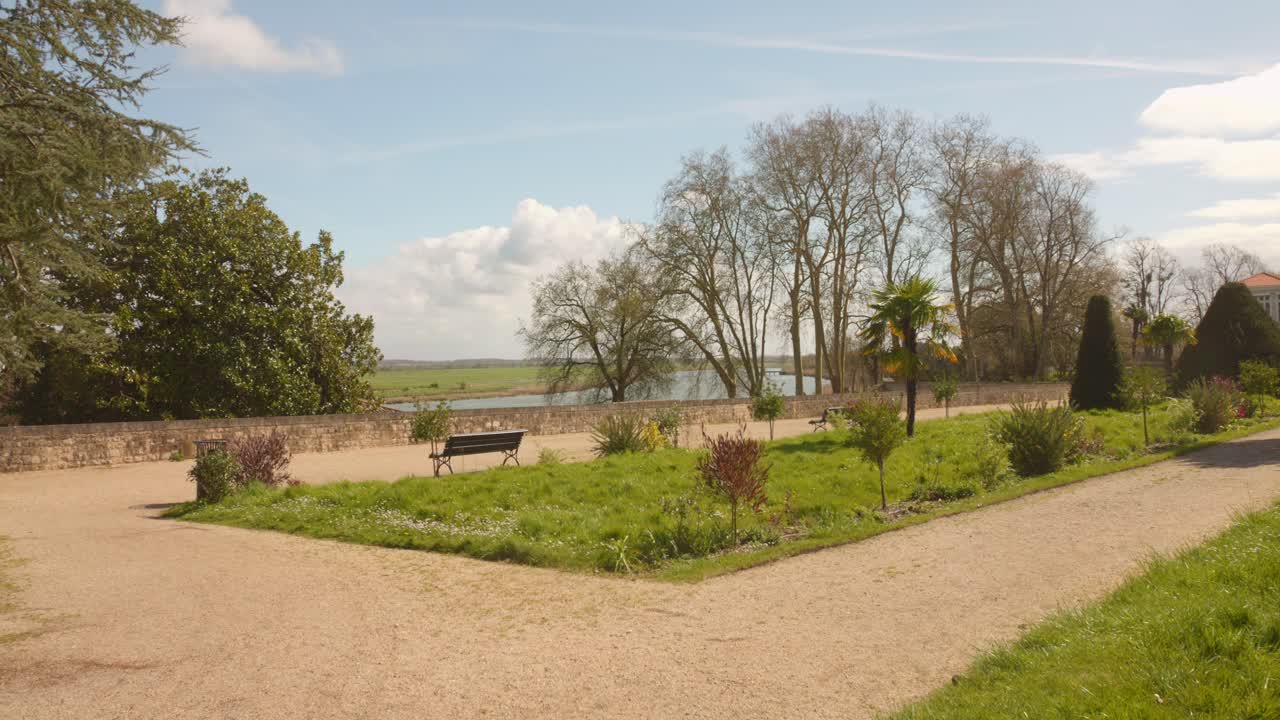 un día soleado en el pintoresco "le jardin des retours de l'arsenal de rochefort" con exuberante vegetación y caminos
