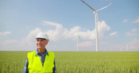 engineer using digital tablet on wind turbine farm 3