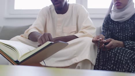 african muslim couple at home in ramadan reading quran holly islam book