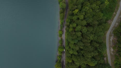 car driving on beautiful forest road at lake klöntalersee switzerland