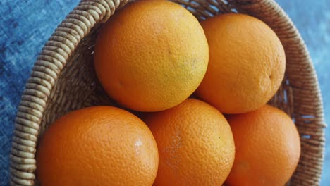 close-up of fresh oranges in a woven basket