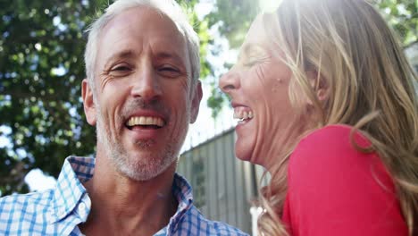 mature couple is embracing and laughing in the street