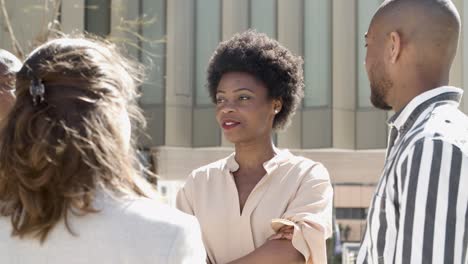 group of young people standing on street and talking