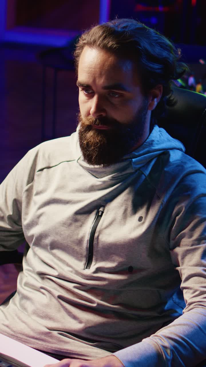 Vertical video Upset player smashing keyboard on his head after being defeated by enemy in videogame tournament