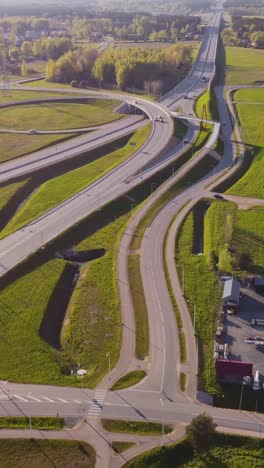 multi level junction of highway in latvia on sunny day, aerial view