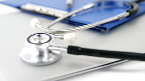 Close-up-of-folder-file-and-pen-with-stethoscope