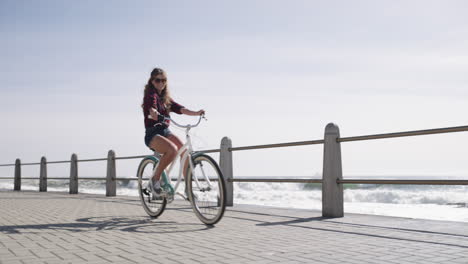 a young woman riding a bicycle on the promenade