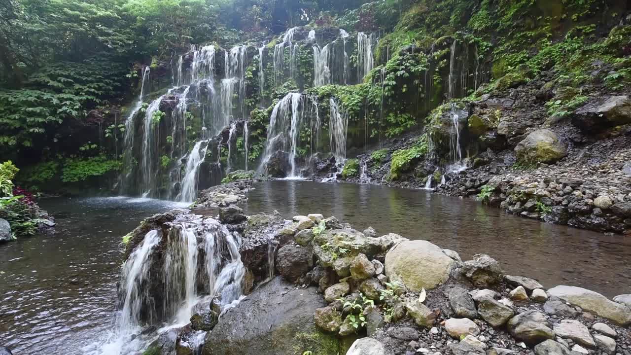 Beautiful view of Banyu Wana Amertha Waterfall in Bali, Indonesia, a hidden tropical waterfall surrounded by lush jungle and natural scenery and Indonesian landscapes
