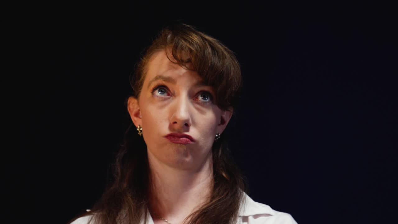 young professional woman waiting for an interview fidgets with her hair