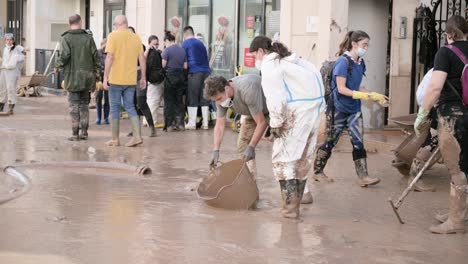 community volunteers help clean up after a devastating flood