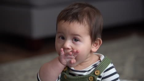 mexican baby playing and sitting in living room