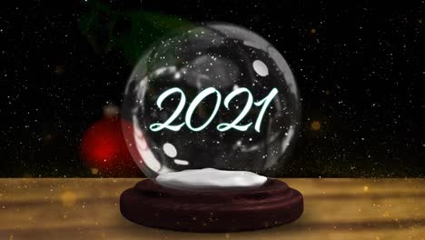 Animation-of-snow-globe-with-2021-and-shooting-star-over-snow-falling