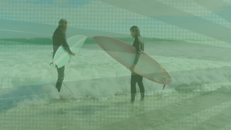 two surfers standing holding surfboards on beach, displaying animated fitness graph and wave icons