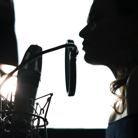 Beauty Woman with Microphone. Professional recording studio. Close-up face. Black and White Square video