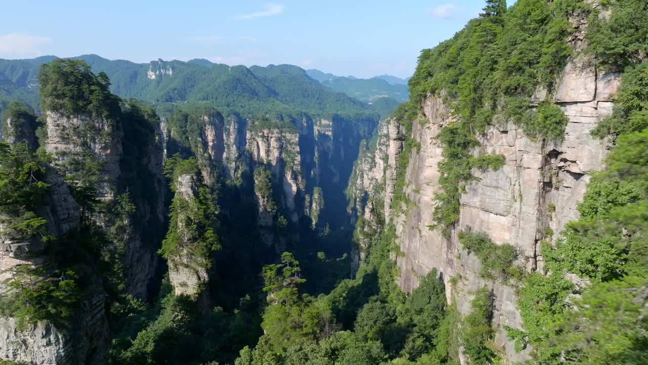 Drone flying between karst mountains of Zhangjiajie natural forest park, China