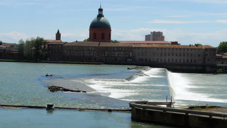 bazacle hydroelectric barrage weir on garonne river - toulouse, france