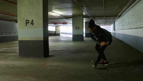 Woman-exercising-at-underground-car-parking-lot-4k