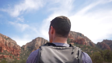 Young-fit-hiker-takes-in-the-surroundings-panoramic-mountain-views-in-Arizona---Concept:-Freedom,-peace,-enjoying