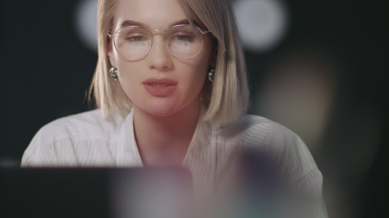 Successful girl working on laptop. Financial analyst working late at workplace