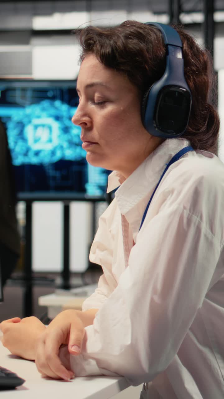 Vertical video Programmer in office listening music, automating workflows using AI