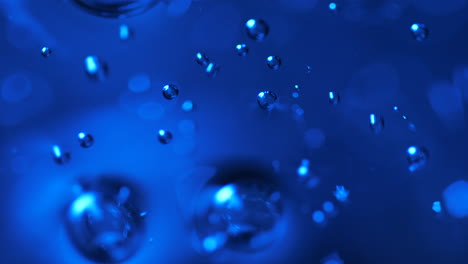 blue abstract bubbles rising in liquid