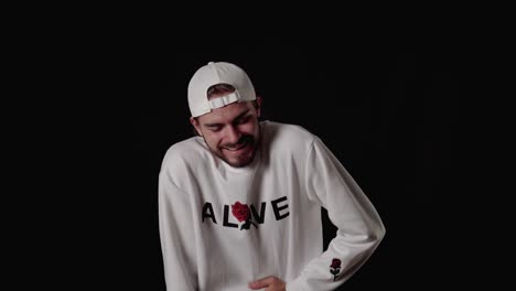 trendy 20s man laughing out loud, happy gesture, wide, black background