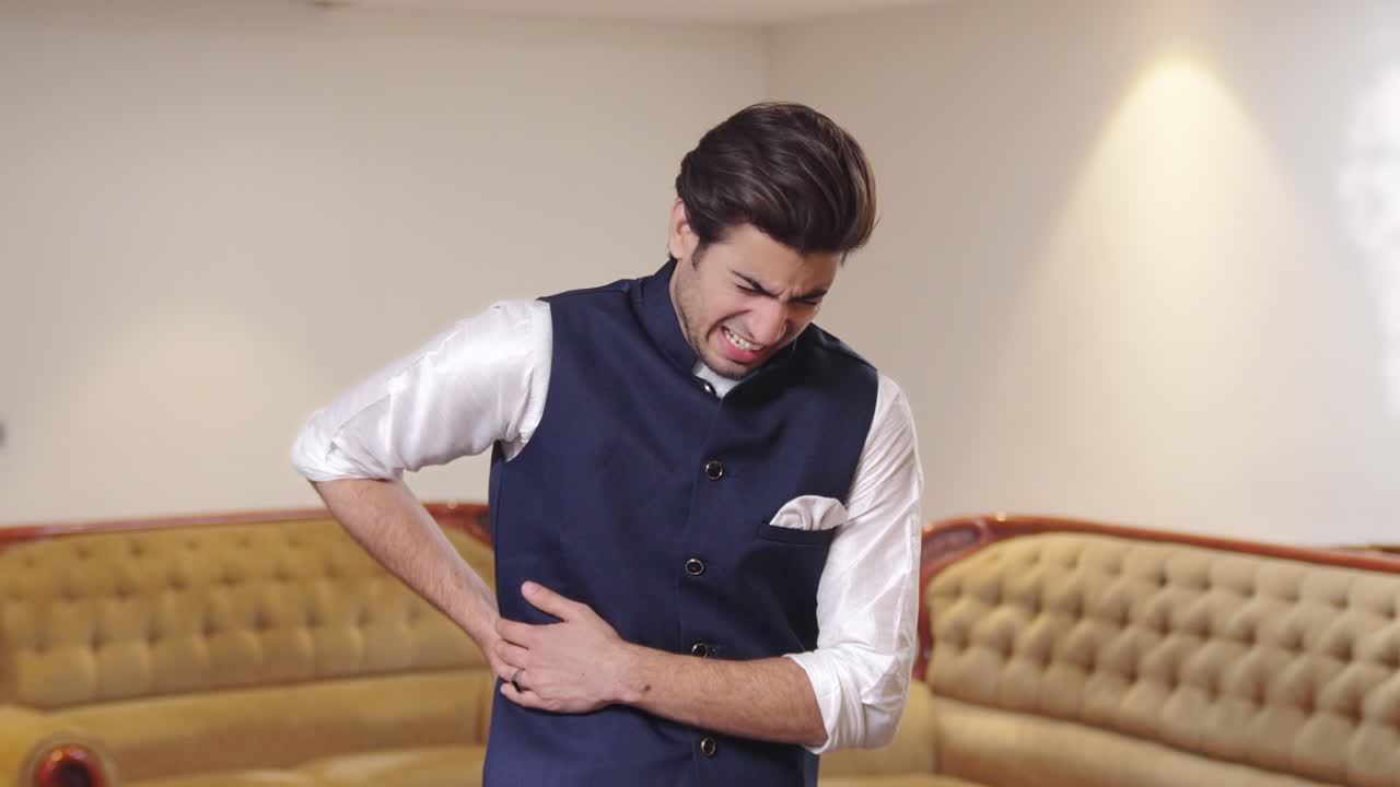 Indian man suffering from back pain