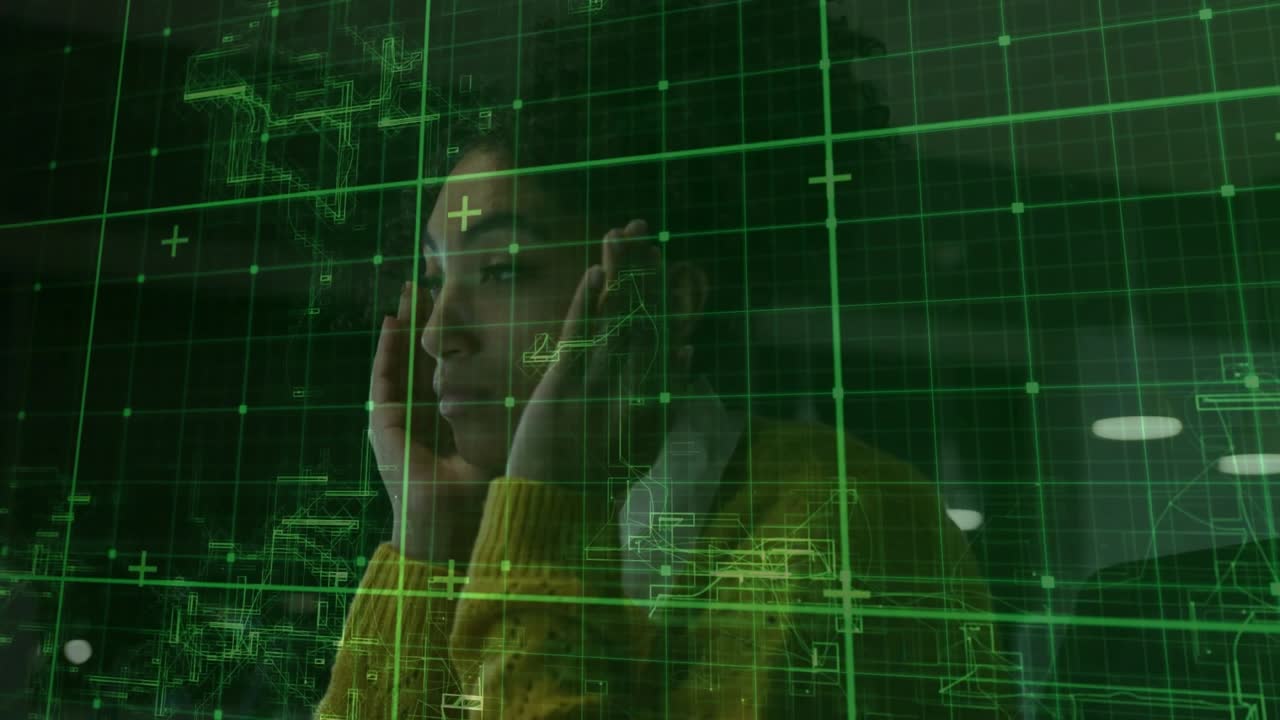 Woman sitting at desk receiving alert, touching face and thinking under clear green technology grid