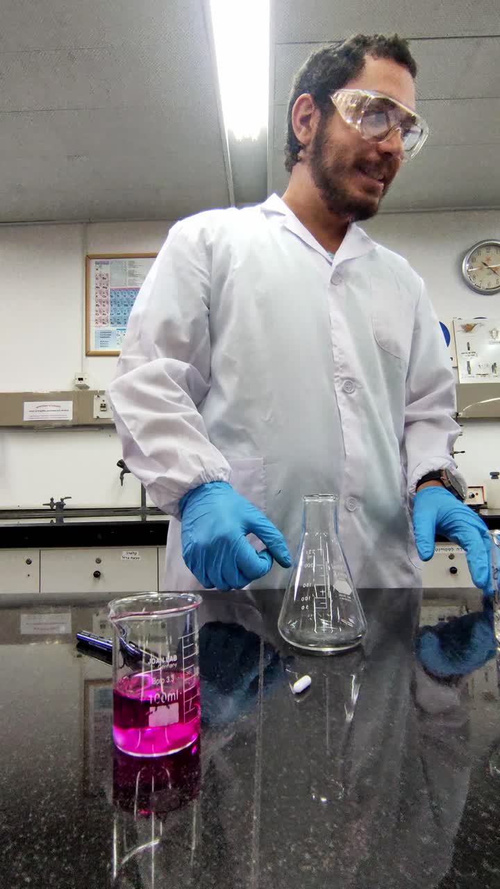 A man in a lab coat is holding a test tube and a beaker