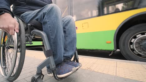 person with a physical disability waiting for city transport with an accessible ramp