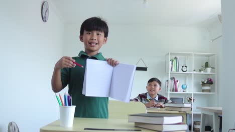 An Asian students studying in class and presenting his blank book page for mock up