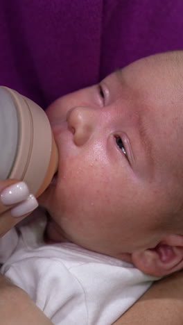 baby being fed with a bottle