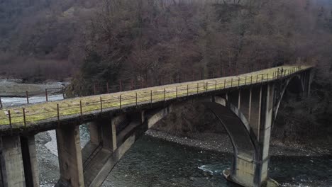 old concrete bridge over a mountain river