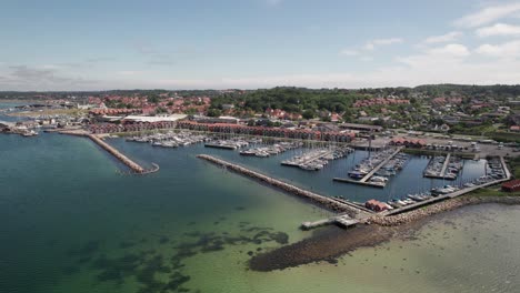 aerial establishing shot of idyllic marina and town in denmark