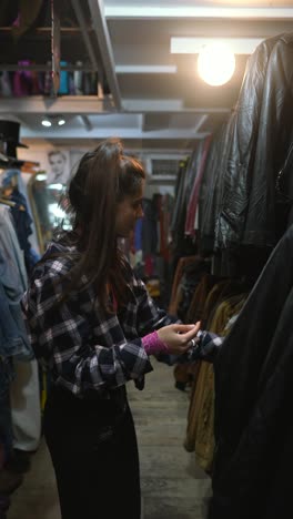 woman shopping for vintage clothes in a thrift store