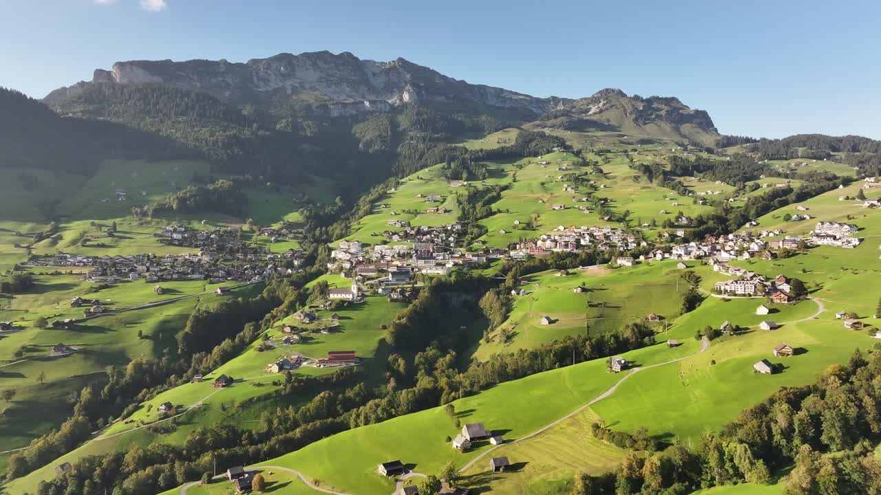 Drone flight over the village of Anden in the Swiss Alps, above Lake Walensee.