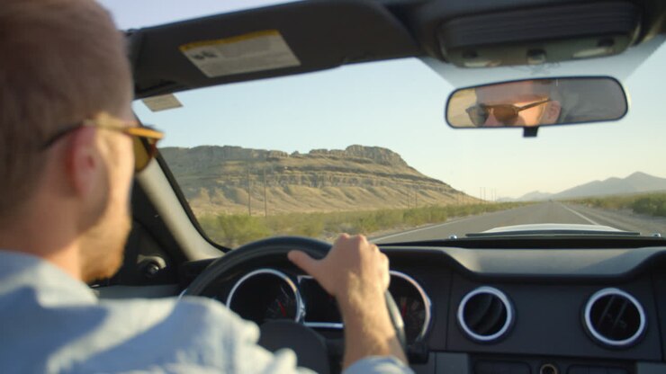 Man In Convertible Car Driving Along Open Road Shot On R3D