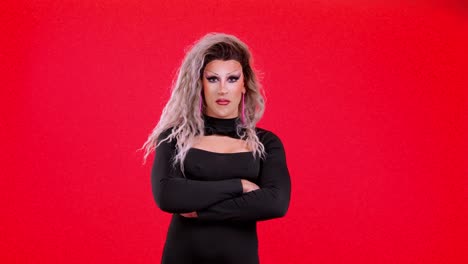 Confident Drag Queen Posing Against a Vibrant Red Background