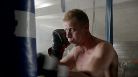 man boxing with punching bag