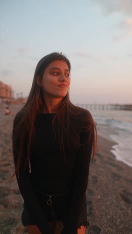 young woman at sunset beach