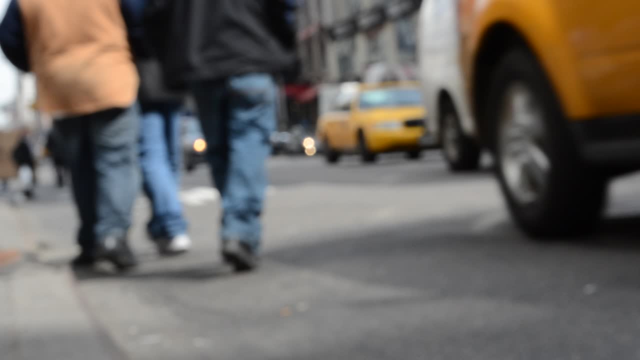 Yellow taxi against people. New York, USA